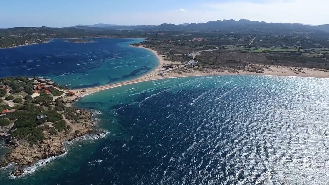 Aerial view of the two bays at Porto Pollo either side of the sandy causeway