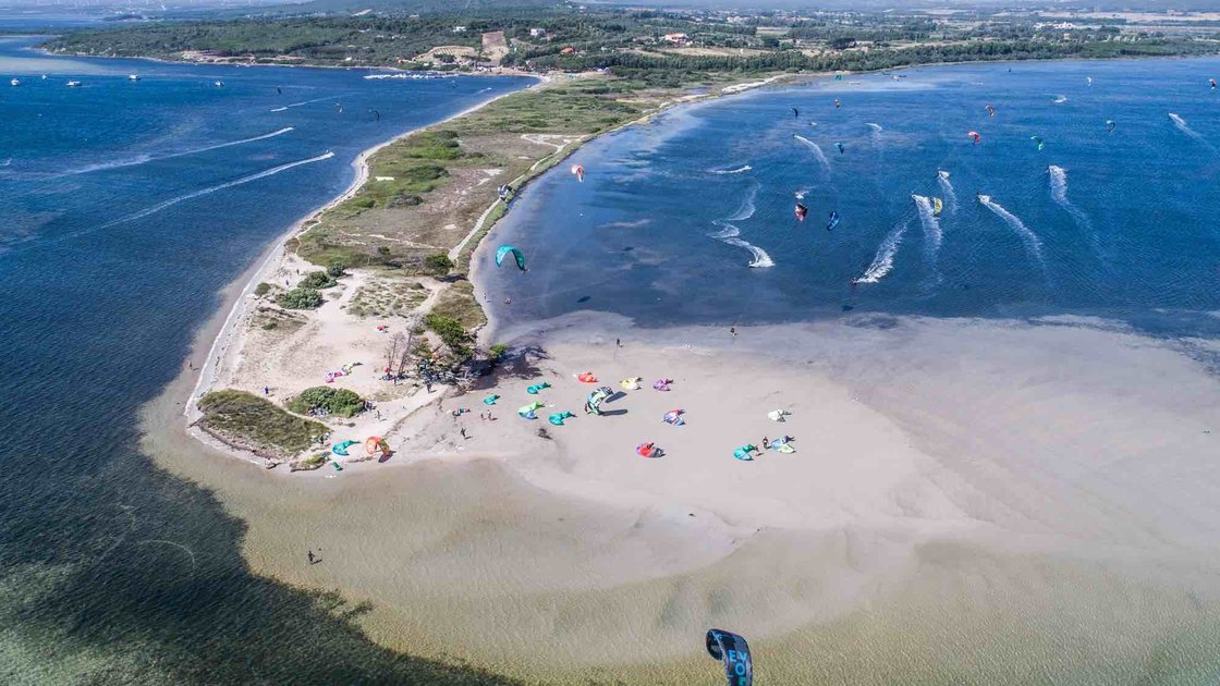 Aerial view of the sandbank and shallow lagoon at Punta Trettu with kites