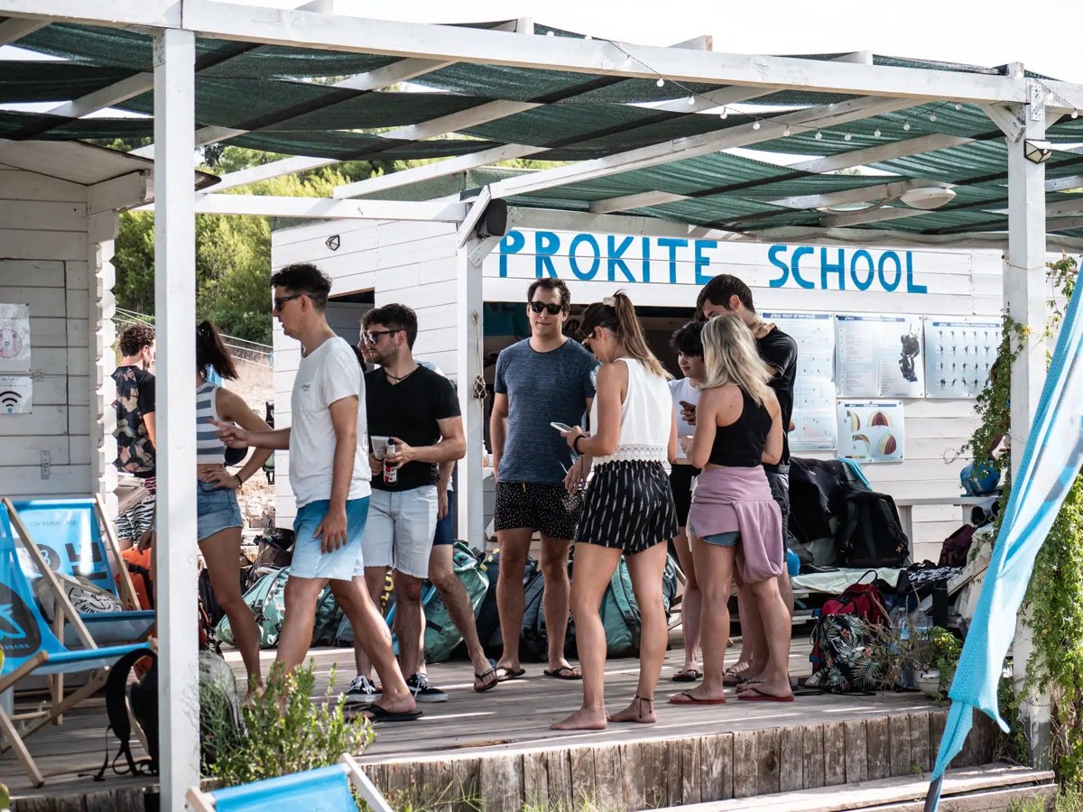 Riders gathering on the deck of the ProKite school at Punta Trettu